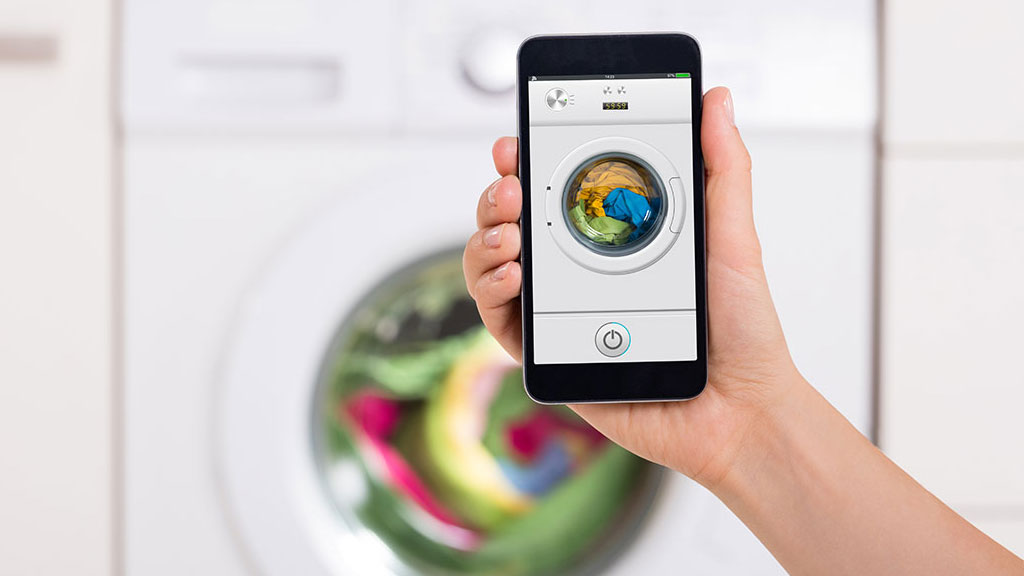 Connected washing machine operating while person walks away